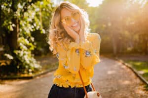stylish smiling woman in yellow blouse wearing sunglasses colorful summer fashion trend